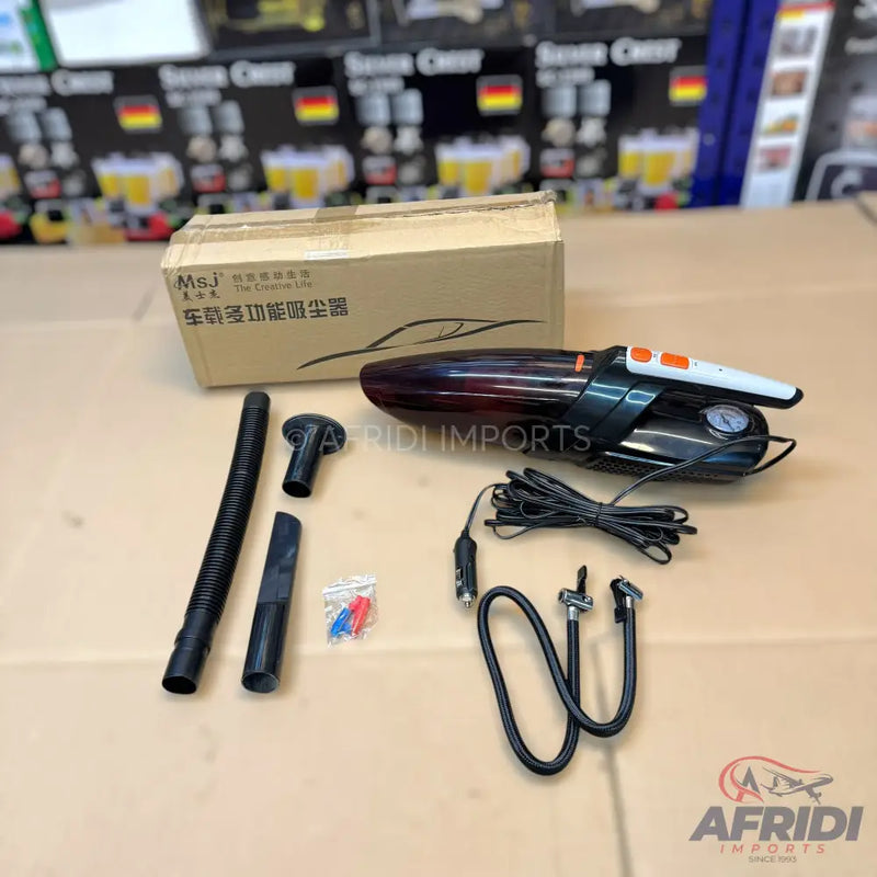 A black and orange portable car vacuum cleaner with multiple attachments and an air compressor.