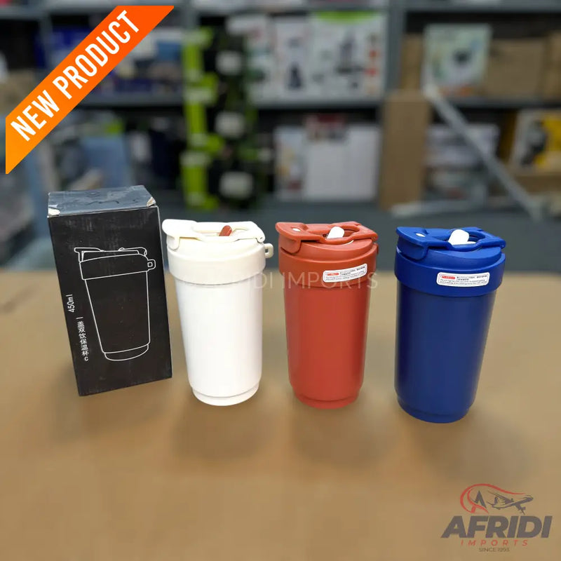 Four insulated tumblers, one in its black packaging, and three in white, red, and blue.