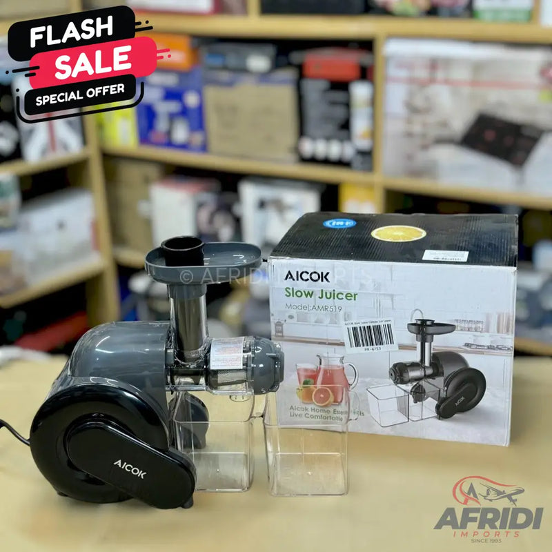 A dark grey Aicok slow juicer with a transparent collection cup and a box.
