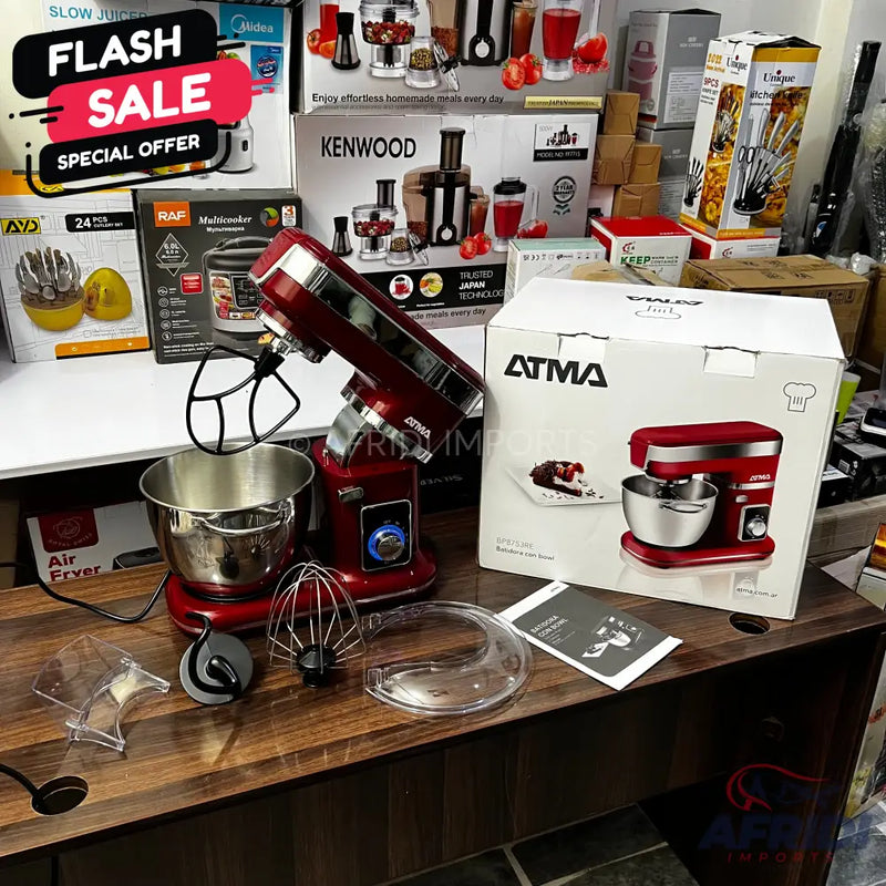 Red stand mixer with a stainless steel bowl and various attachments.