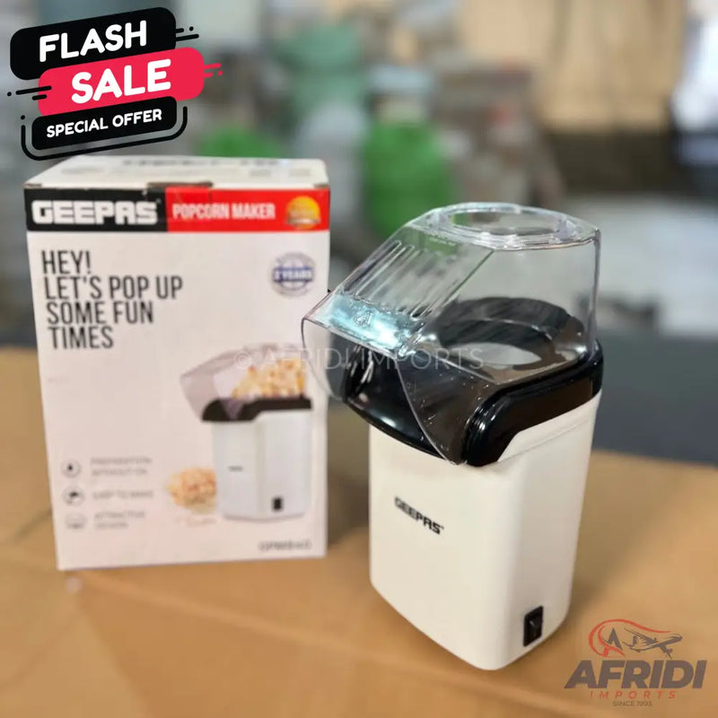 White and black electric popcorn maker with a transparent lid.