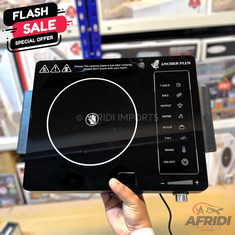 Black portable induction cooktop with touch controls and pre-set cooking functions.