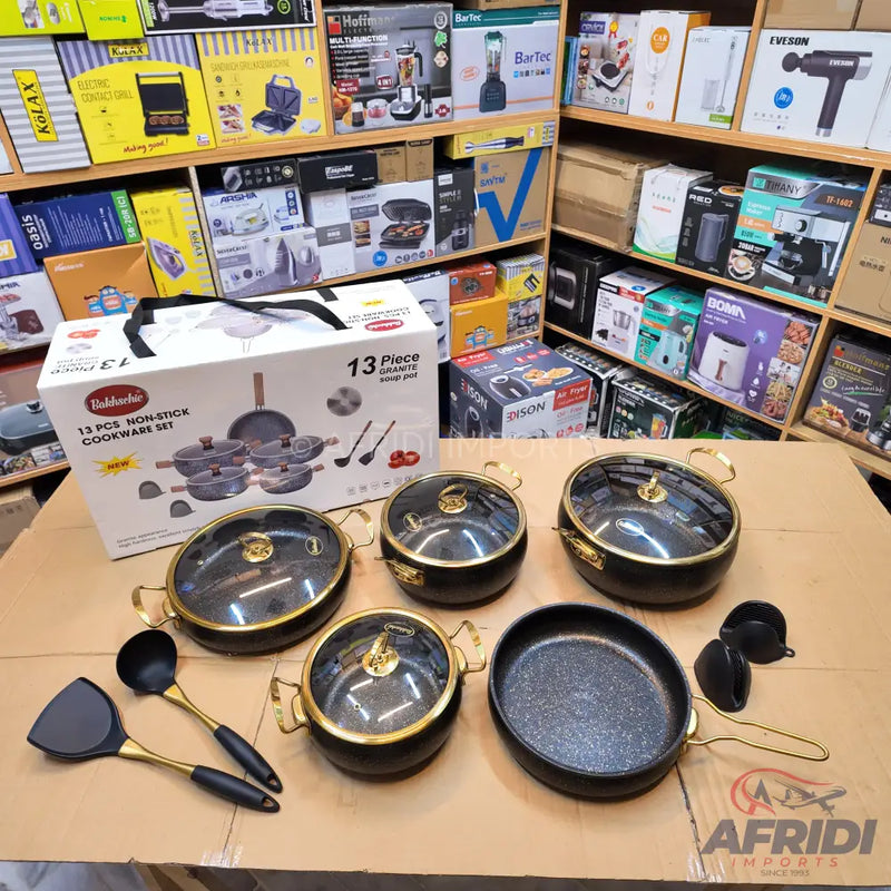 A 13-piece non-stick cookware set in black and gold with glass lids and matching utensils.