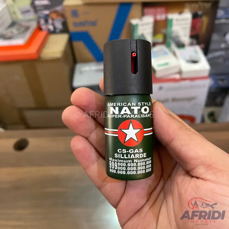 A dark green pepper spray canister with a black top.