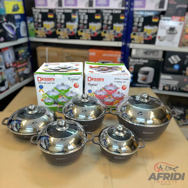 A set of six dark-colored cooking pots with shiny, reflective lids and two boxed sets of similar cooking pots.