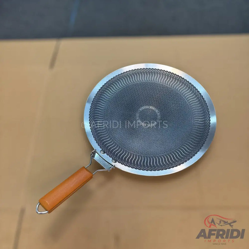 Round flat griddle with a textured non-stick surface and a wooden handle.