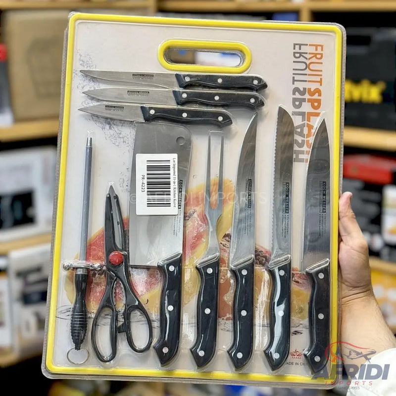 A packaged set of kitchen knives, including a cleaver, carving fork, sharpening steel, and scissors, all with black handles.