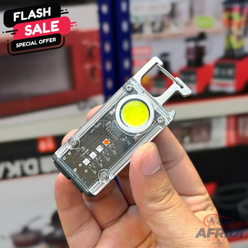 A clear plastic mini flashlight with a yellow LED and a carabiner clip.