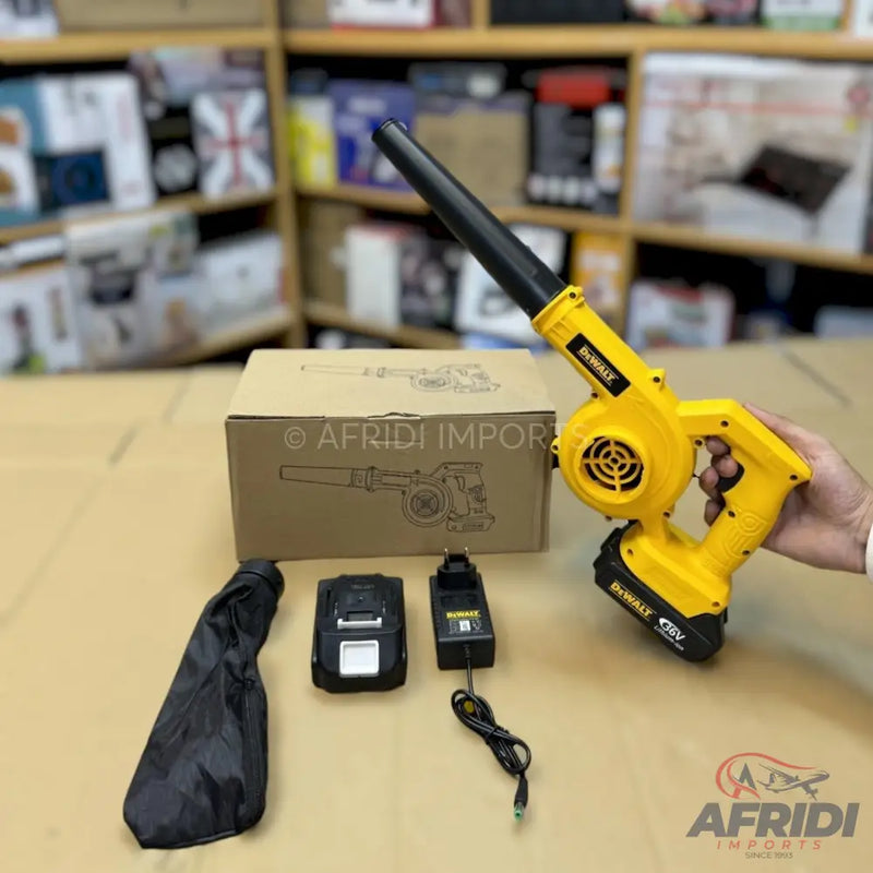 A yellow and black cordless leaf blower with a battery and charger.