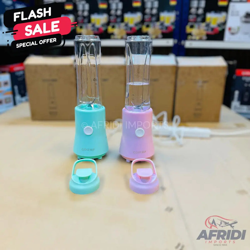 Two portable blenders, one teal and one pink, with detachable clear cups and lids.