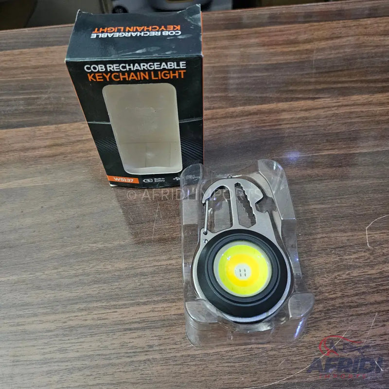Rechargeable COB keychain light with a built-in carabiner and multiple tools.