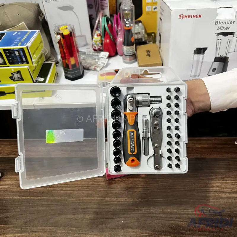 A compact ratchet and screwdriver bit set in a clear plastic case.