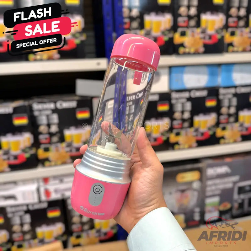 Pink portable blender with a clear mixing cup.