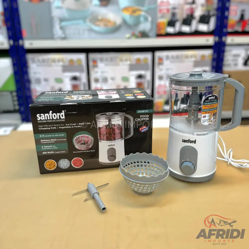 A white and gray electric food chopper with a clear bowl and a separate blade attachment.
