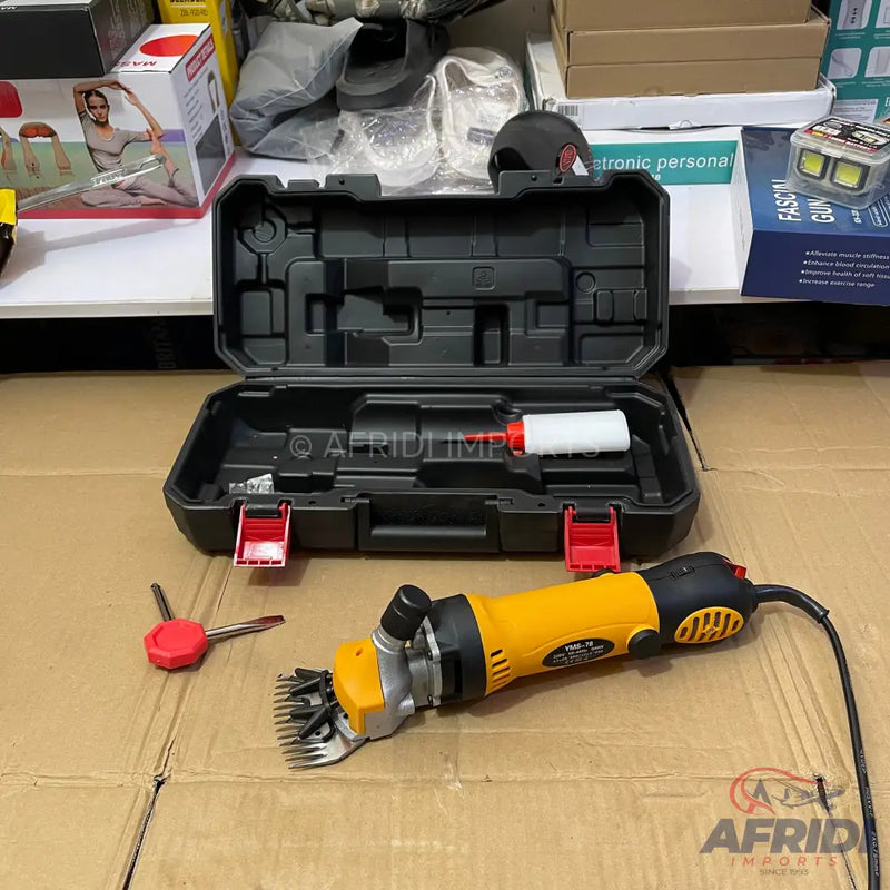 Yellow and black electric sheep shears with a carrying case and accessories.