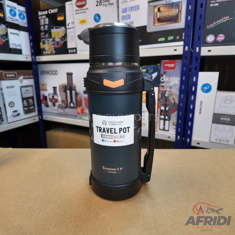 Black travel thermos with an orange accent and a side handle.