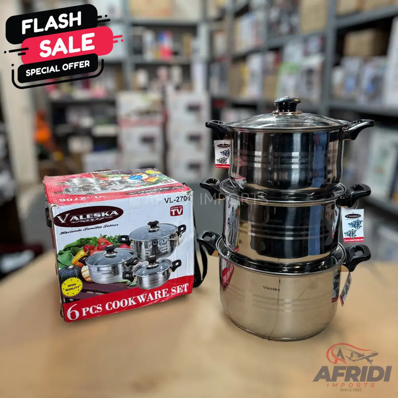 A set of stainless steel pots with glass lids, including a boxed 6-piece cookware set.