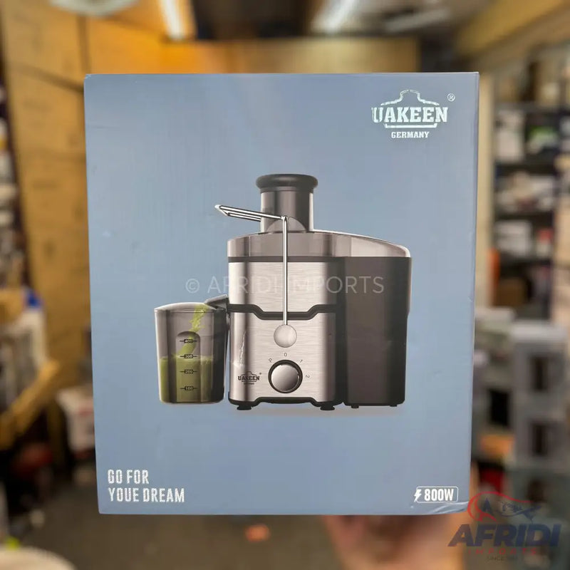 A silver and black juicer with a clear pulp container.