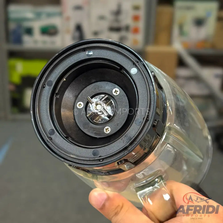The base of a clear glass blender jar with a black plastic blade assembly.