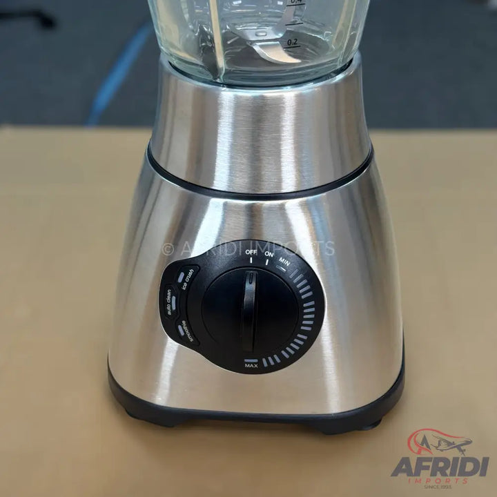 Stainless steel blender with a glass jar and a control dial for various speed settings and functions.