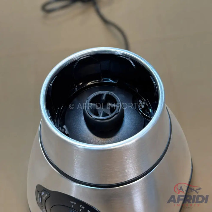 Stainless steel blender base with a black control panel and a visible drive shaft.