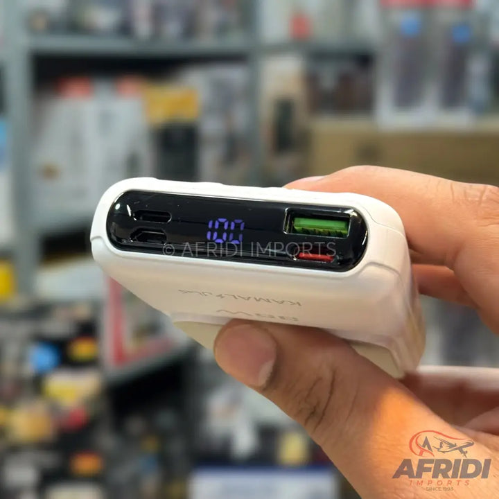White power bank with a digital display showing ’100’’ and multiple USB ports, including one green and one red.