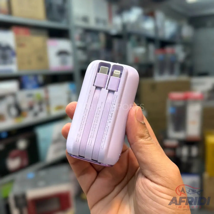 Lavender-colored power bank with integrated USB-C and Lightning cables.