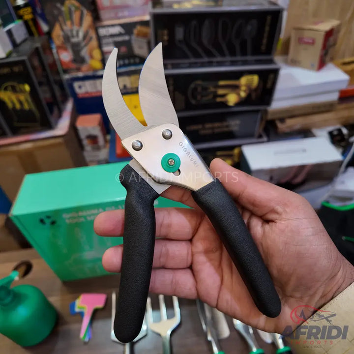 Silver-bladed garden shears with black handles and a green adjustment knob.
