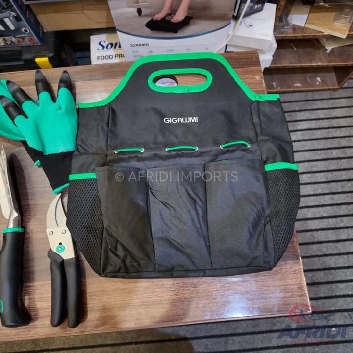 Black and green gardening tool bag with multiple pockets, gloves, and pruning shears.