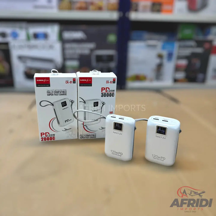 Two white portable power banks with digital displays and multiple charging ports, packaged in their retail boxes.