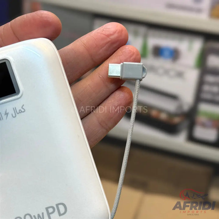 A white rectangular power bank with a connected grey braided USB-C cable.