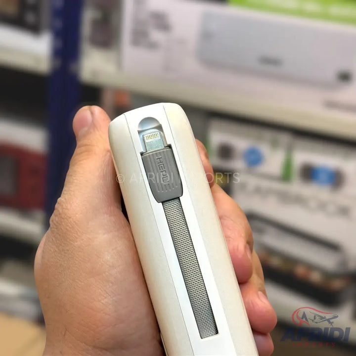 White portable power bank with an integrated retractable Lightning cable.