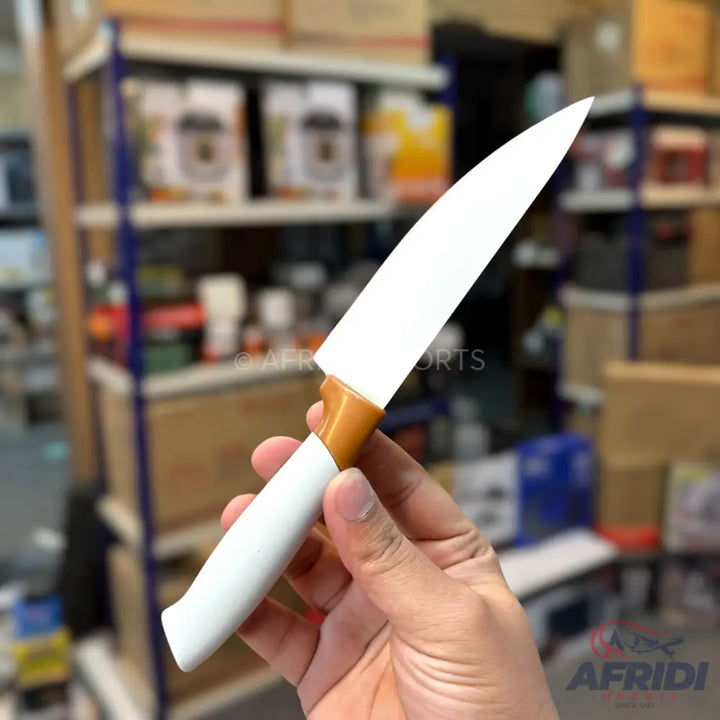 White ceramic chef’s knife with a brown and white handle.