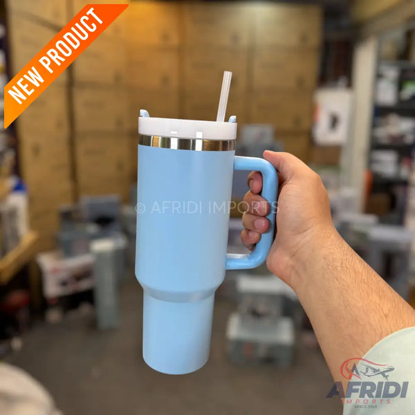 A light blue insulated travel mug with a handle, lid, and straw.