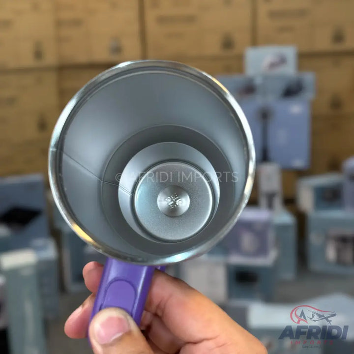 Stainless steel insulated mug with a purple handle.