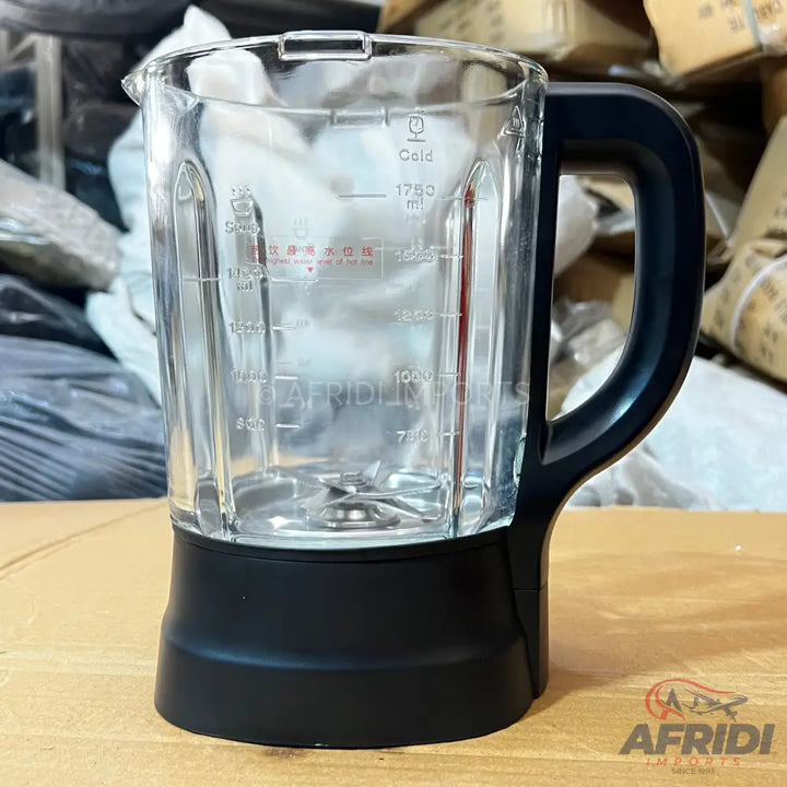 Glass blender jar with a black handle and base.