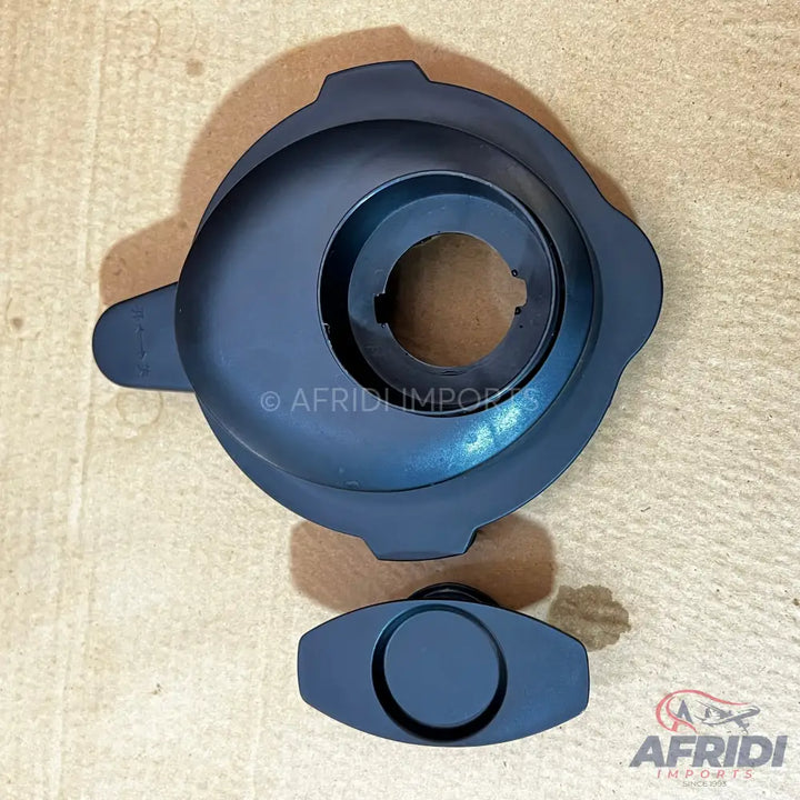 Dark gray blender lid with a removable cap.