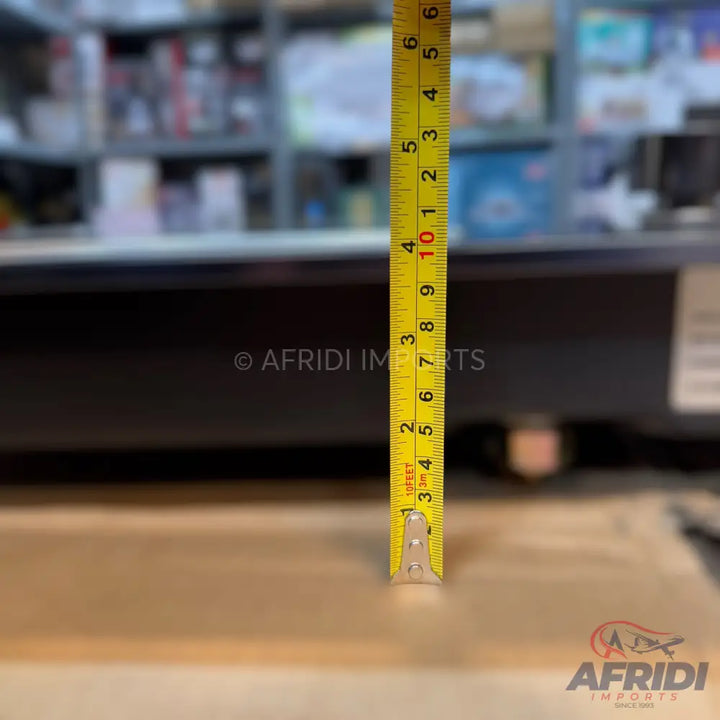 Yellow measuring tape with black and red markings.