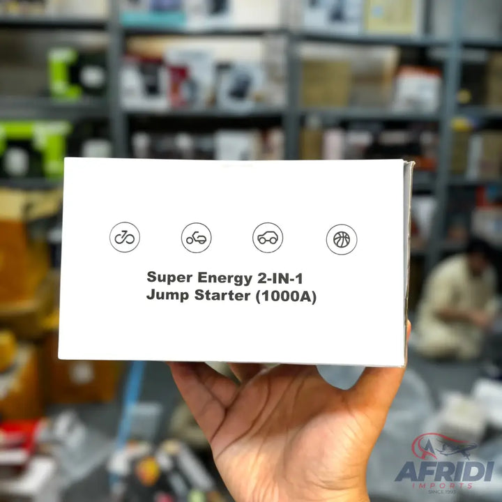 White box for a ’Super Energy 2-IN-1 Jump Starter (1000A)’ with icons for a bicycle, motorcycle, car, and basketball.
