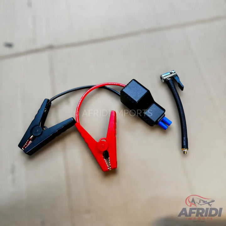 Car battery jump starter clamps with an air pump adapter.
