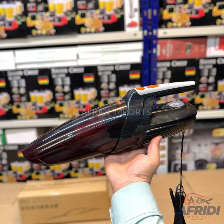 Dark red and black handheld car vacuum cleaner with an orange and white handle.