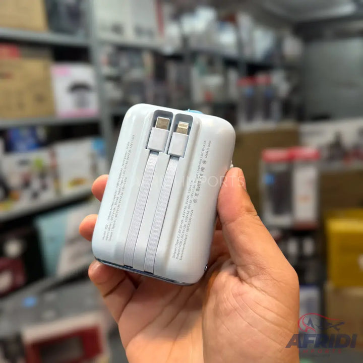 White portable power bank with built-in USB-C and Lightning charging cables.