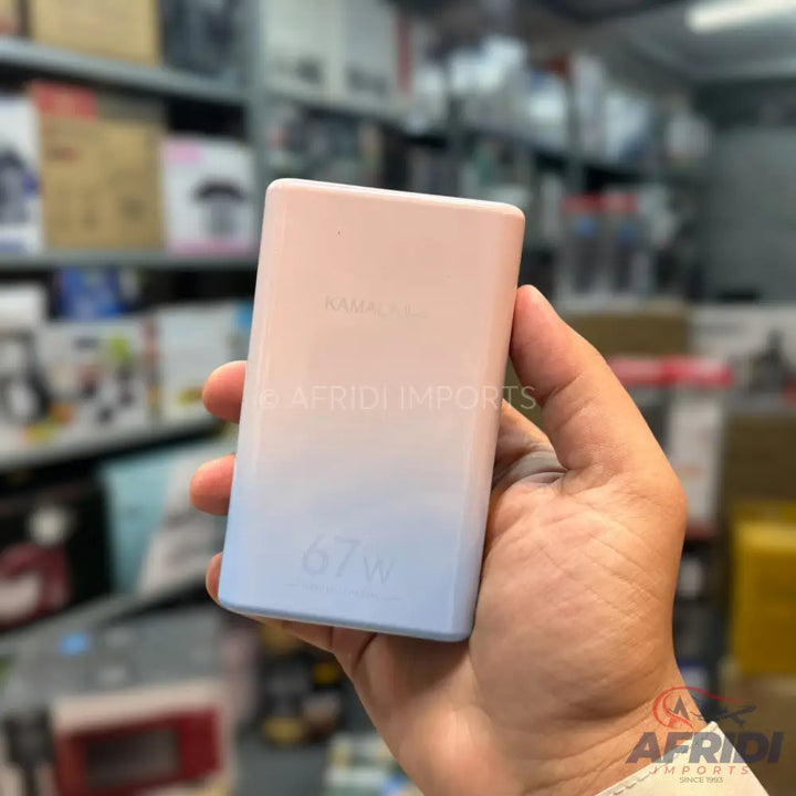 A gradient pink-to-blue power bank held in a hand.