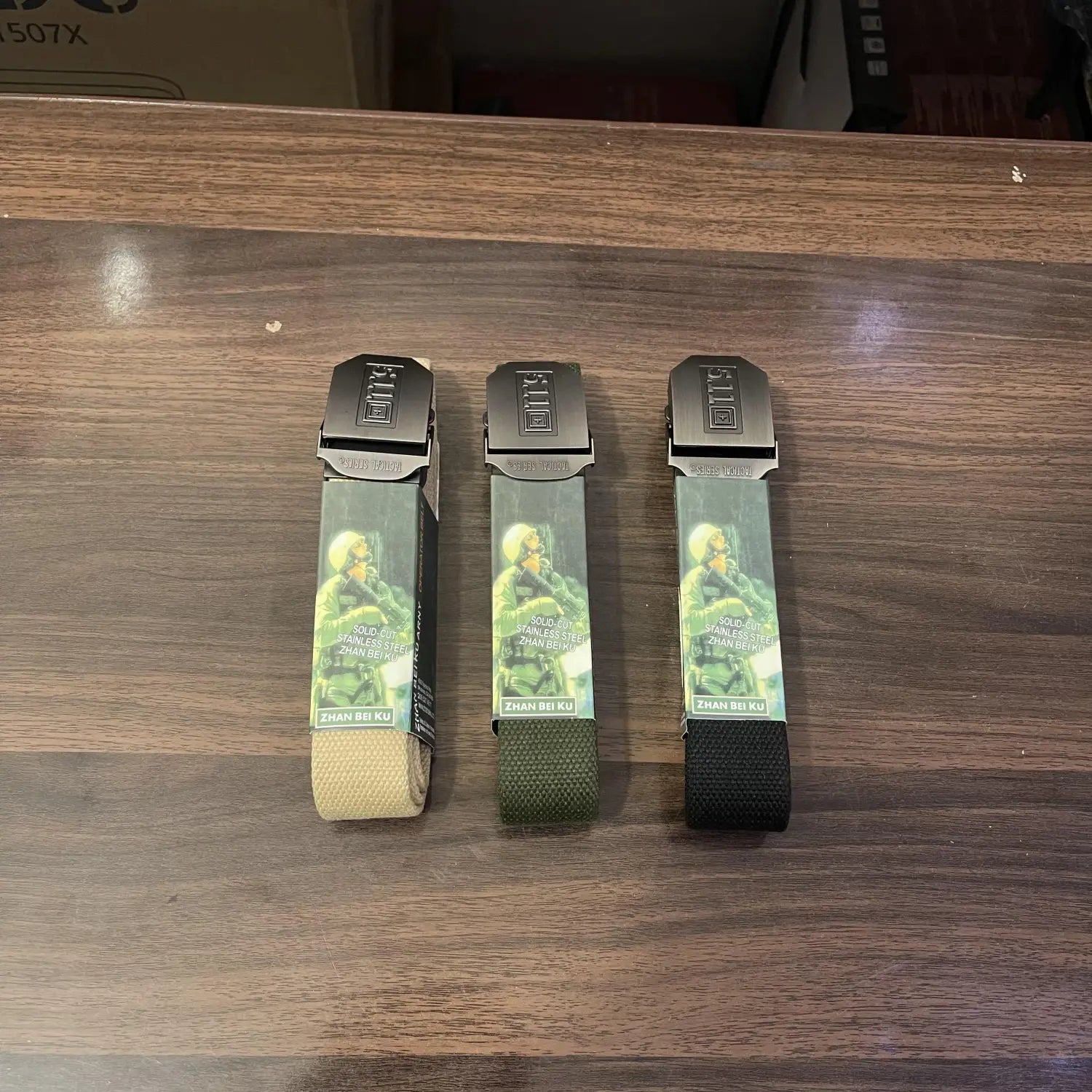 Lot Imported tactical belts in tan, olive green, and black displayed for sale