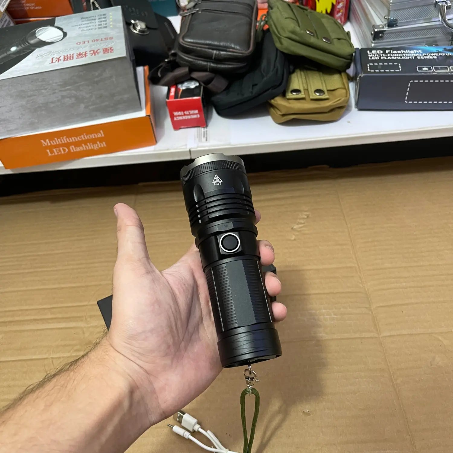 Imported high beam flashlight with black LED, side button, and silver bezel for optimal illumination