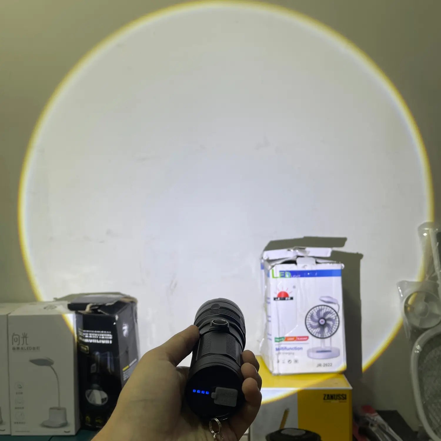 Handheld black imported high beam flashlight with blue indicator light for beam flashlight use