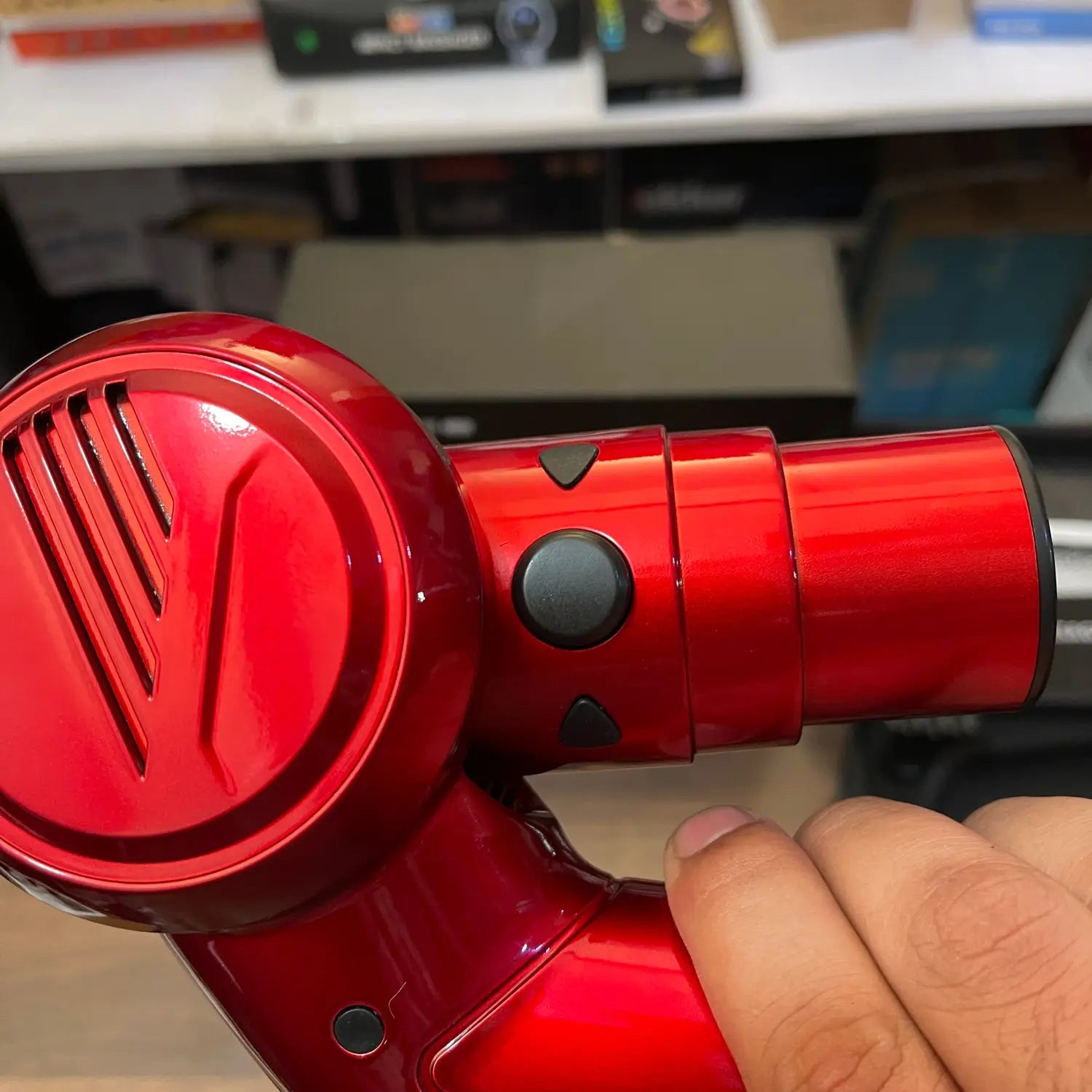 Shiny red folding massager gun LE8 with black control buttons for effective relaxation