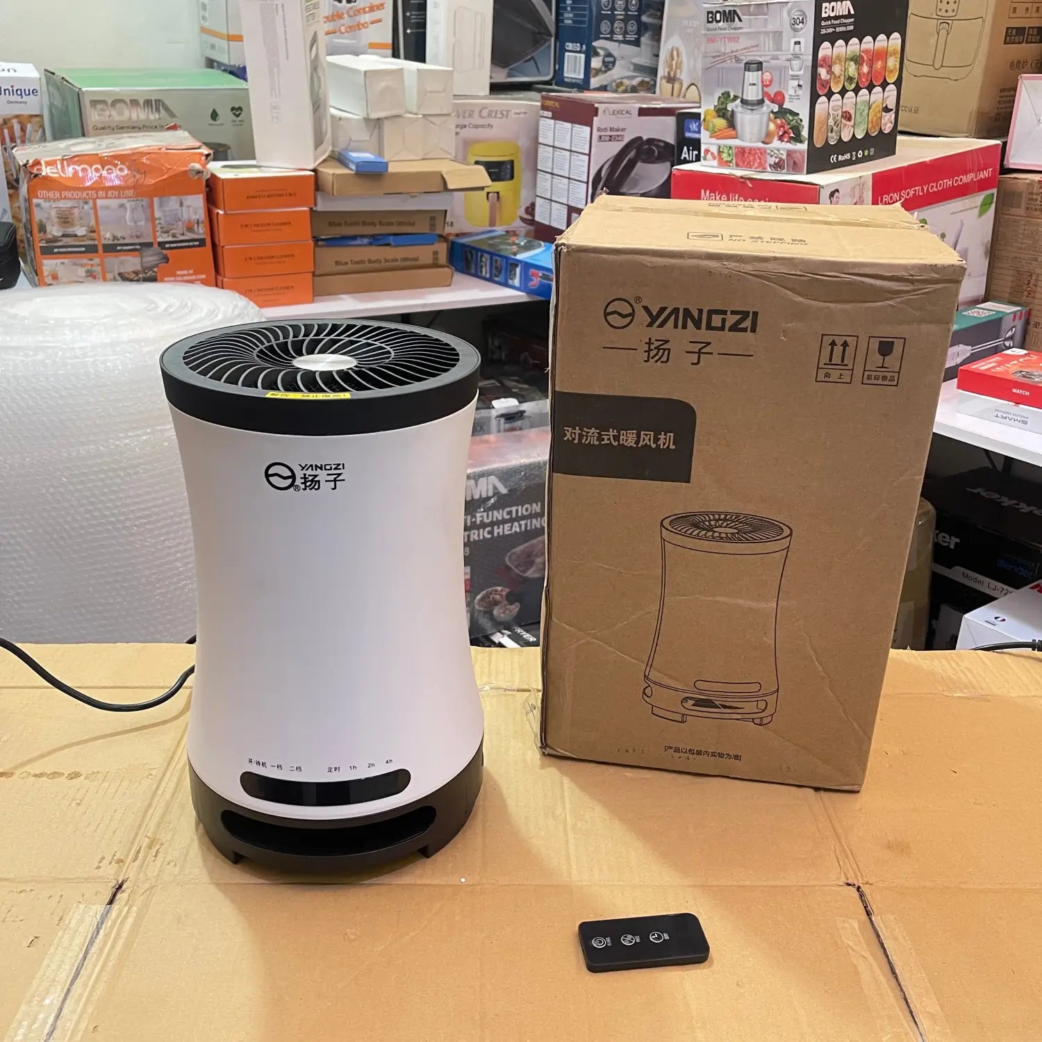 White and black portable electric heater with remote control for efficient heating.
