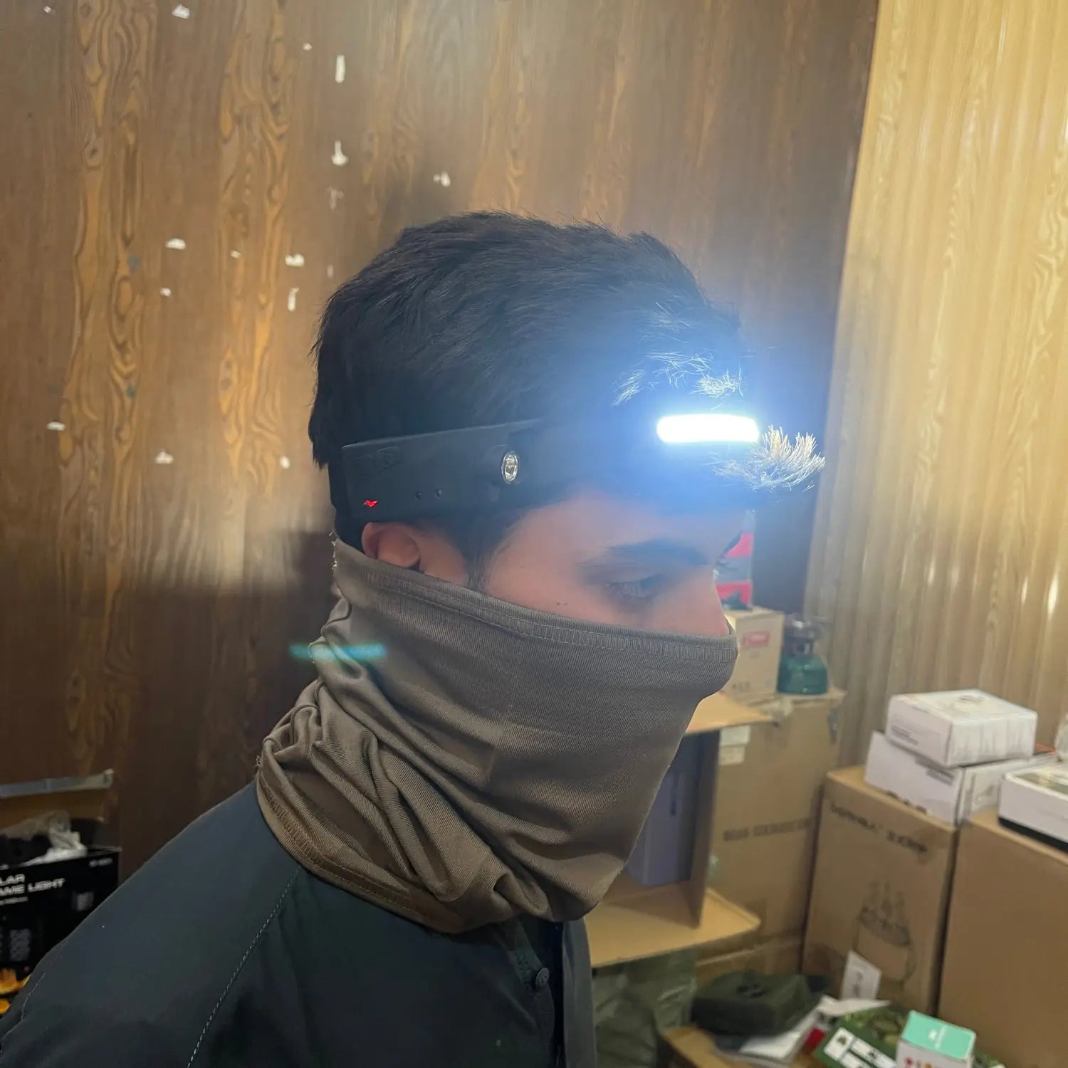 Person wearing a bright LED headlamp with face covering showcasing versatile lighting performance