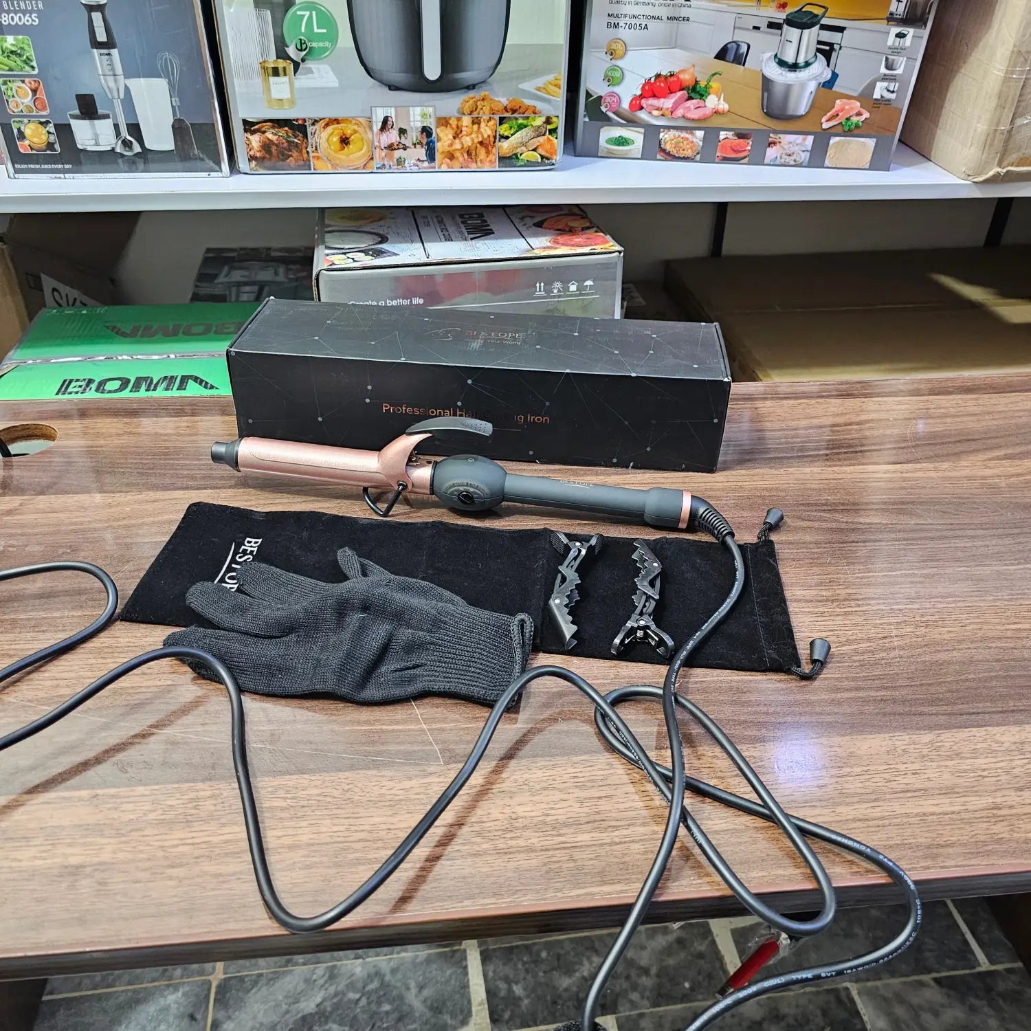 Rose gold and black curling iron with heat-resistant glove and hair clips for perfect curls